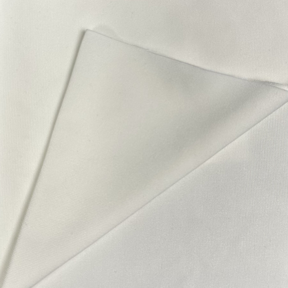Close-up of a light gray fabric with a subtle texture on a white background