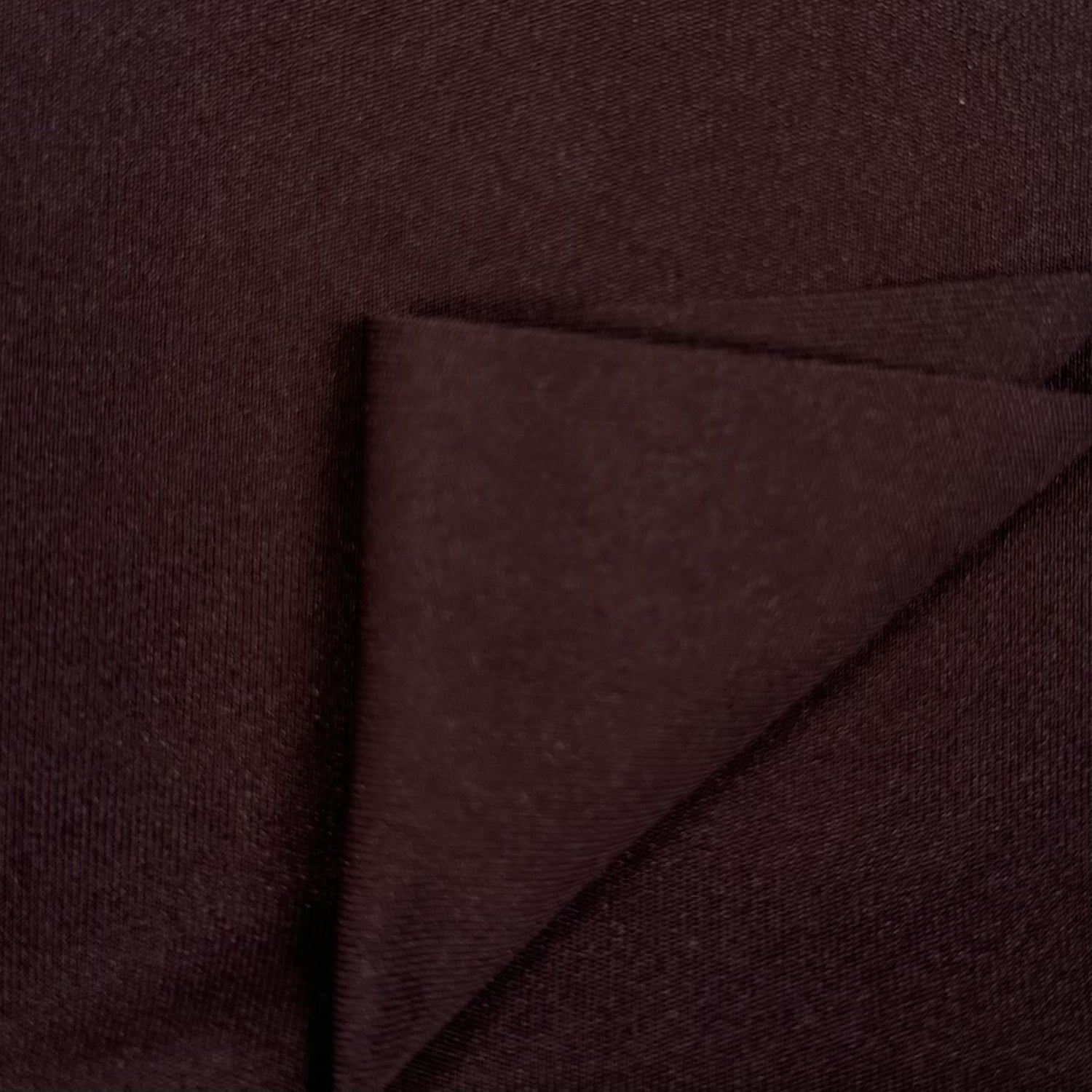 Close-up of dark brown fabric with a diagonal fold
