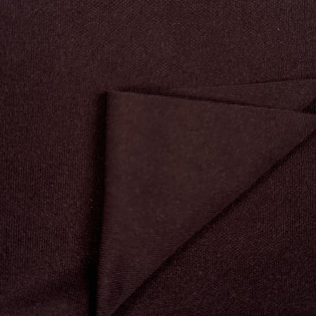 Close-up of dark brown fabric with a diagonal fold