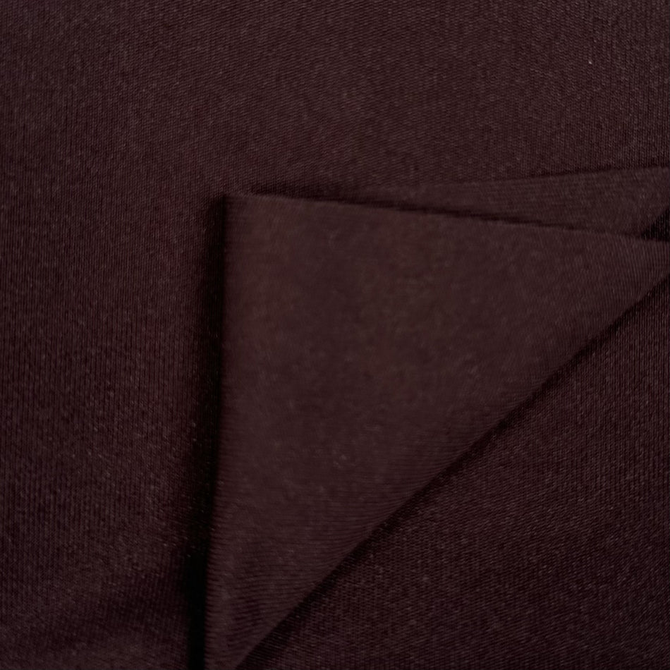 Close-up of dark brown fabric with a diagonal fold