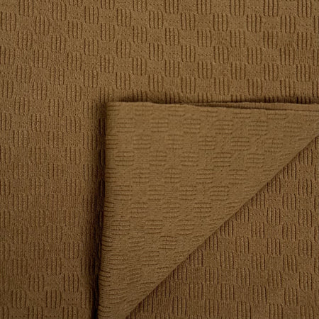 Brown textured fabric with a folded corner