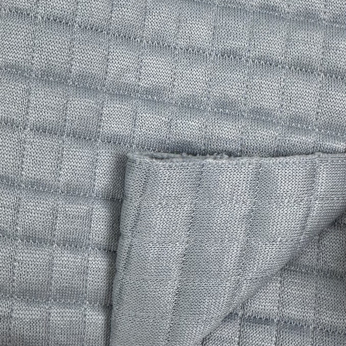 Close-up of textured gray fabric with a subtle pattern