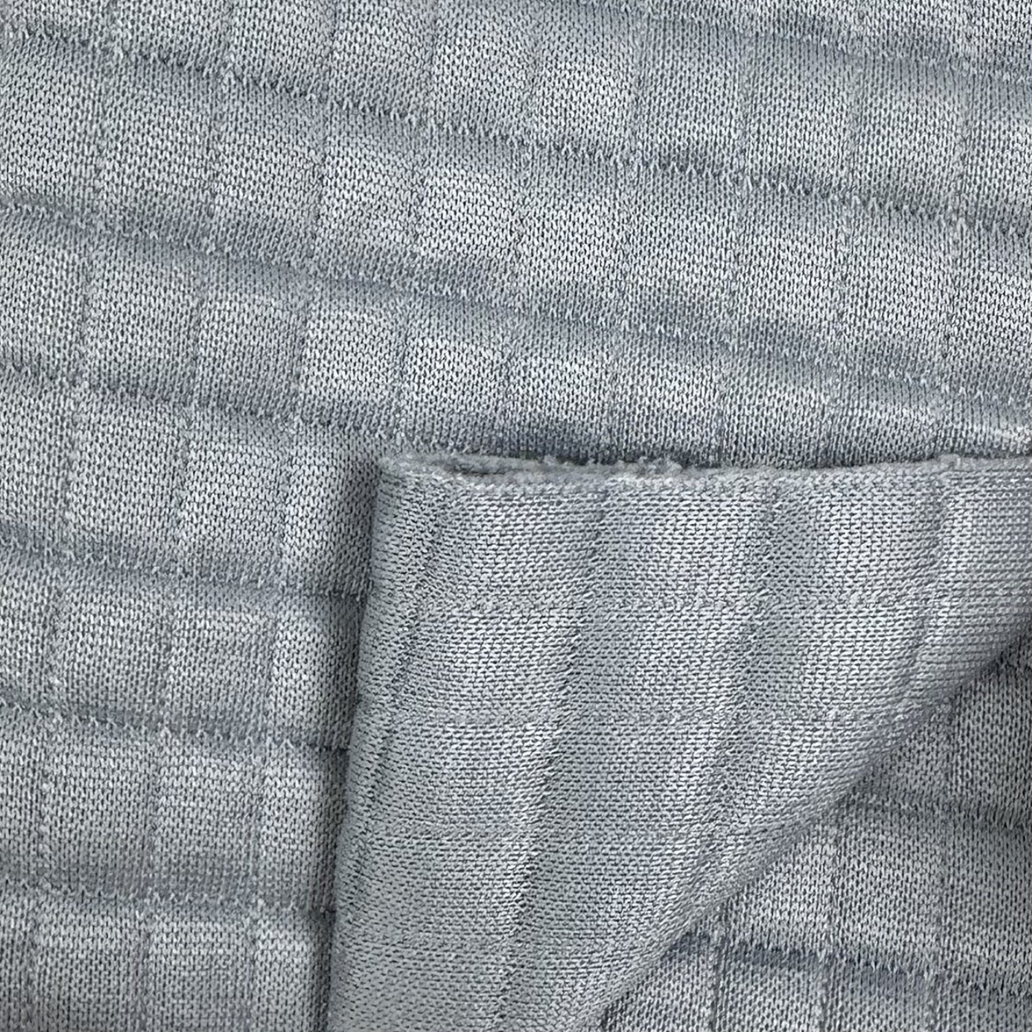 Close-up of textured gray fabric with a subtle pattern