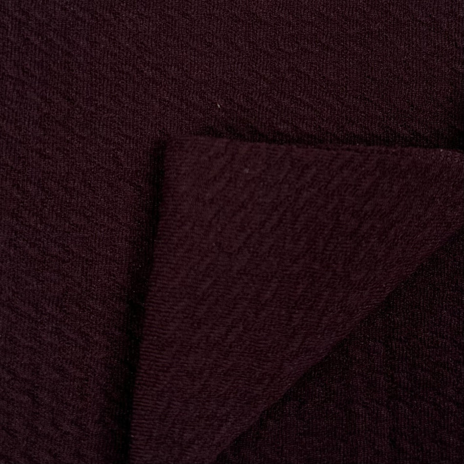 Close-up of dark brown fabric with a textured pattern
