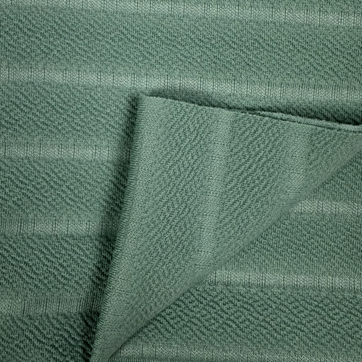 Close-up of green fabric with a textured pattern