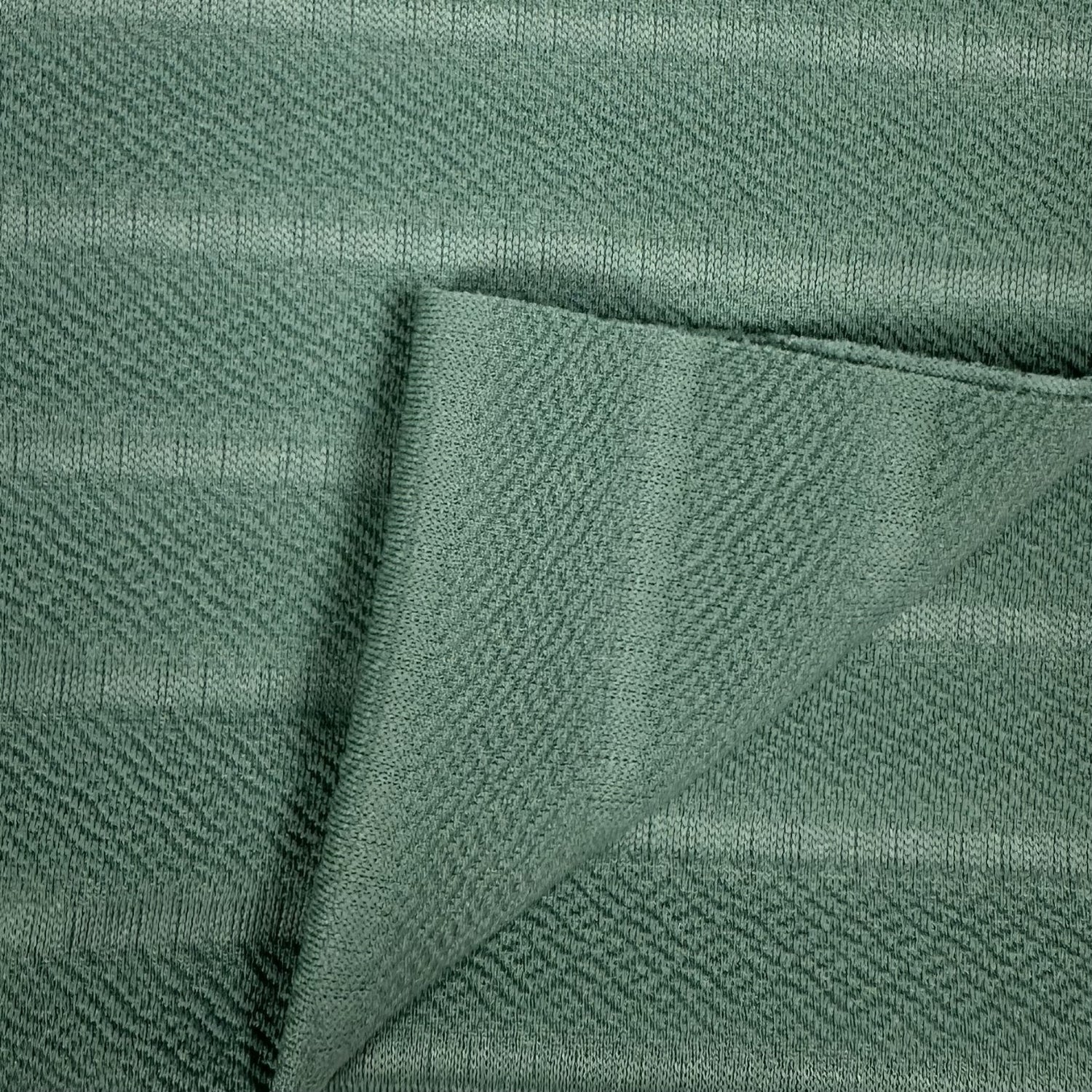 Close-up of green fabric with a textured pattern