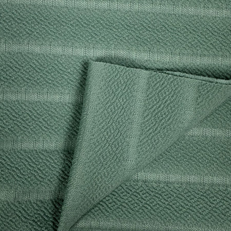 Close-up of green fabric with a textured pattern