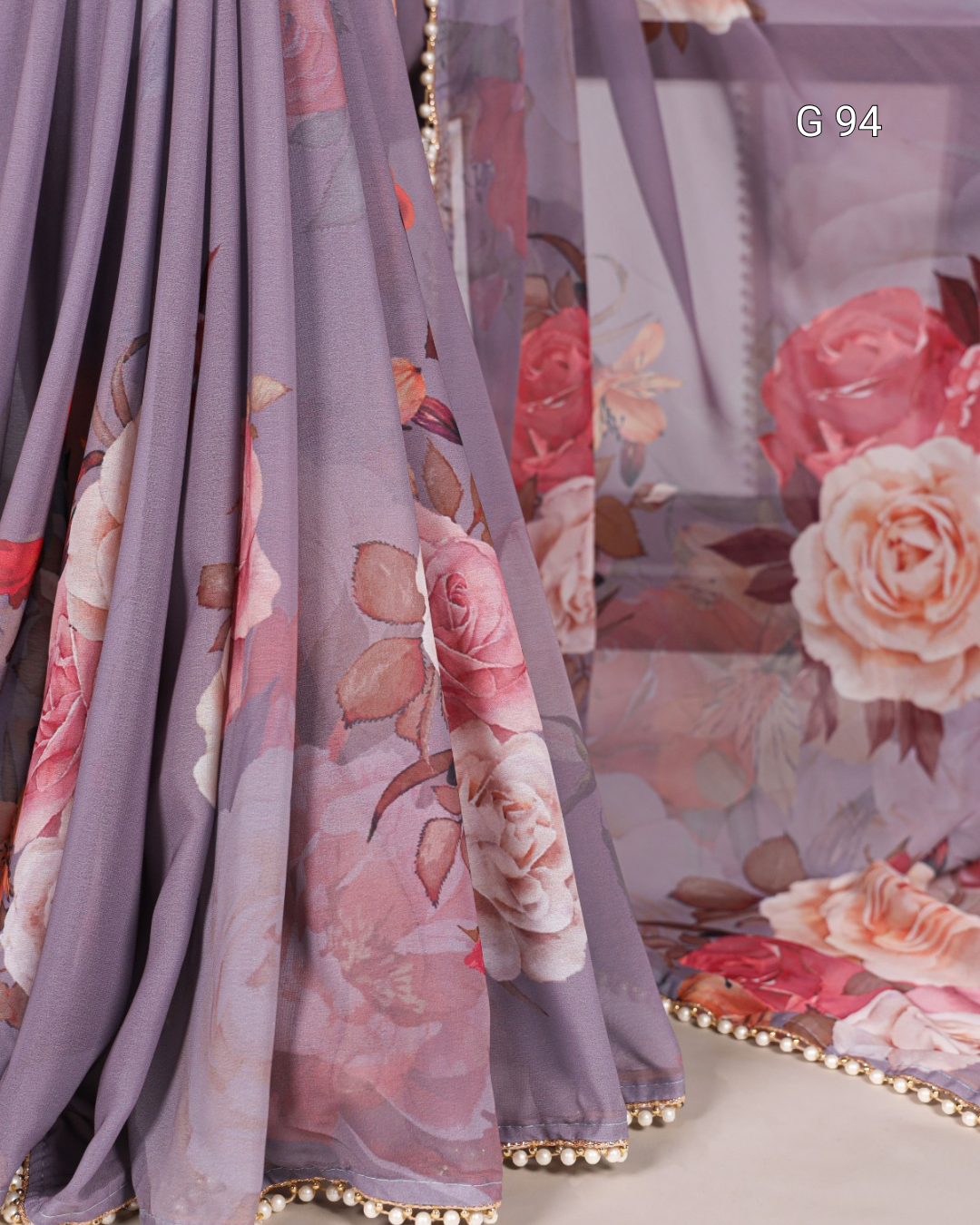 Floral fabric with pink and purple tones on a gray background