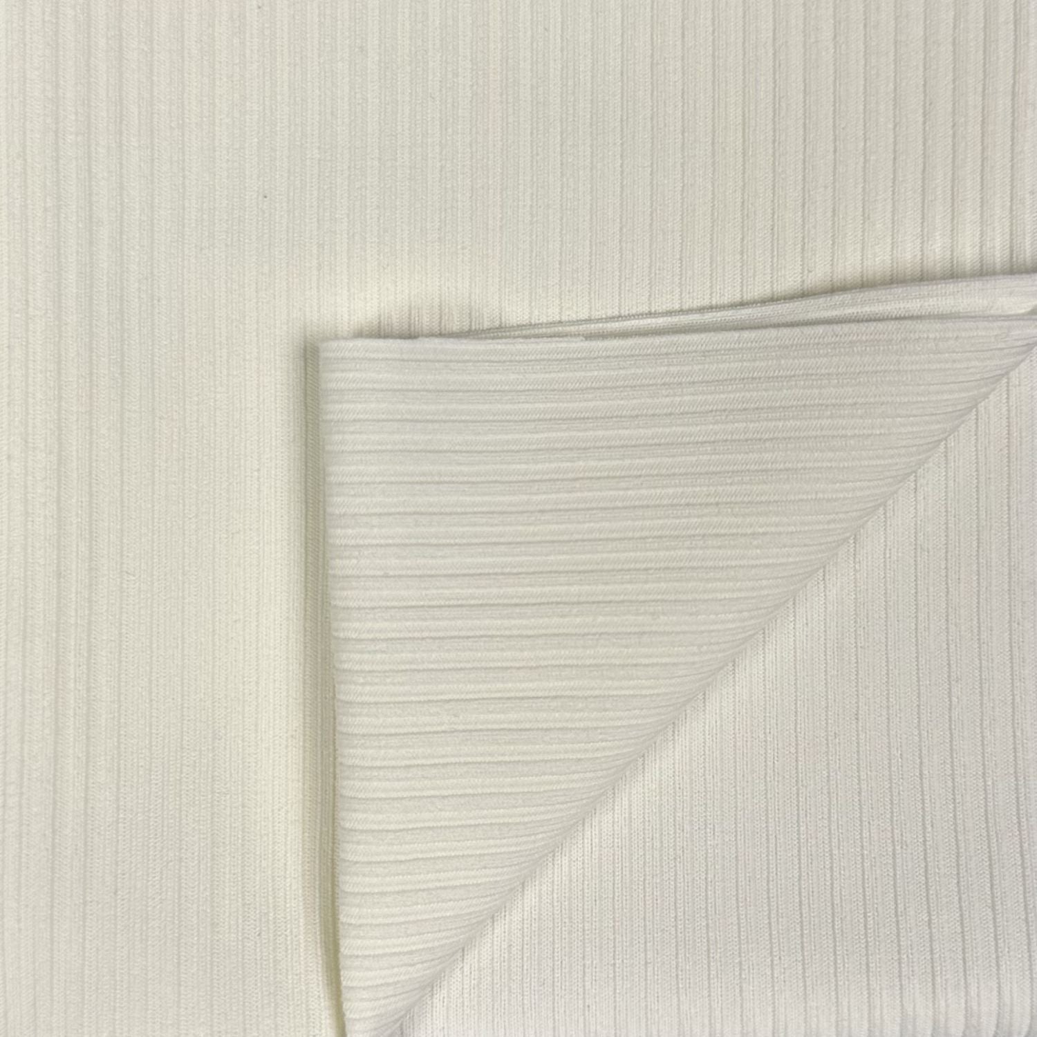 Close-up of textured white paper with a diagonal crease on a light gray background