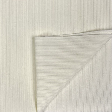 Close-up of textured white paper with a diagonal crease on a light gray background