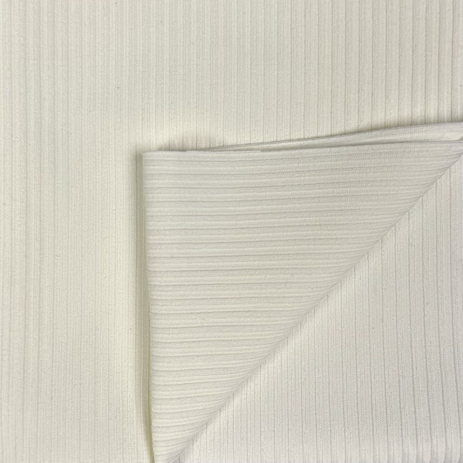 Close-up of textured white paper with a diagonal crease on a light gray background