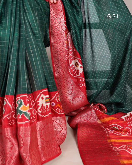 Traditional saree with green and red patterns, featuring intricate designs.
