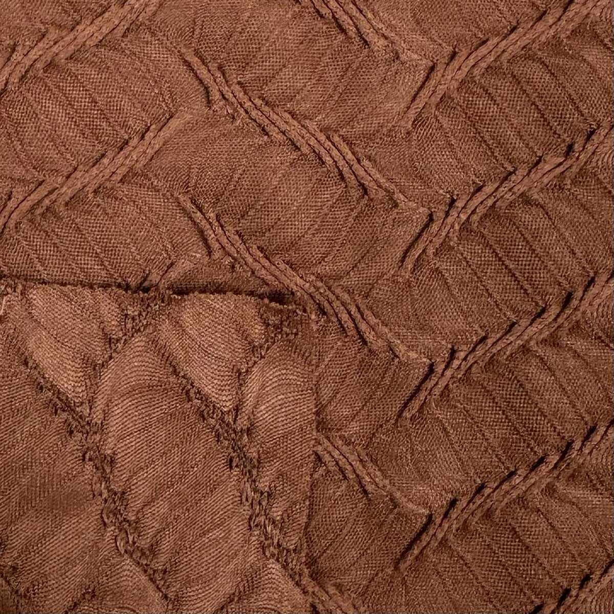 Close-up of brown textured fabric with a diamond pattern