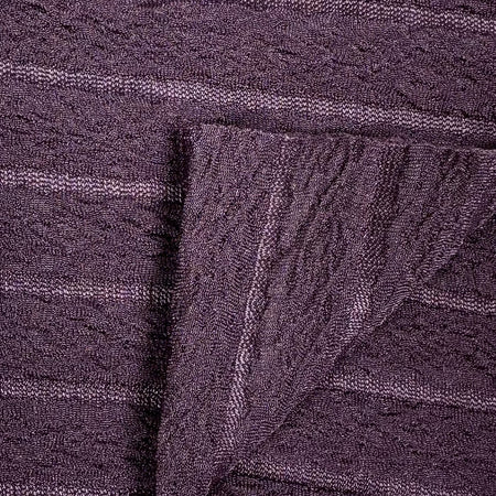 Close-up of textured purple fabric with a folded edge