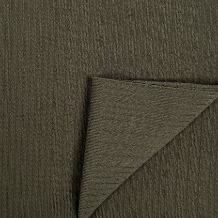 Close-up of dark green fabric with a textured pattern