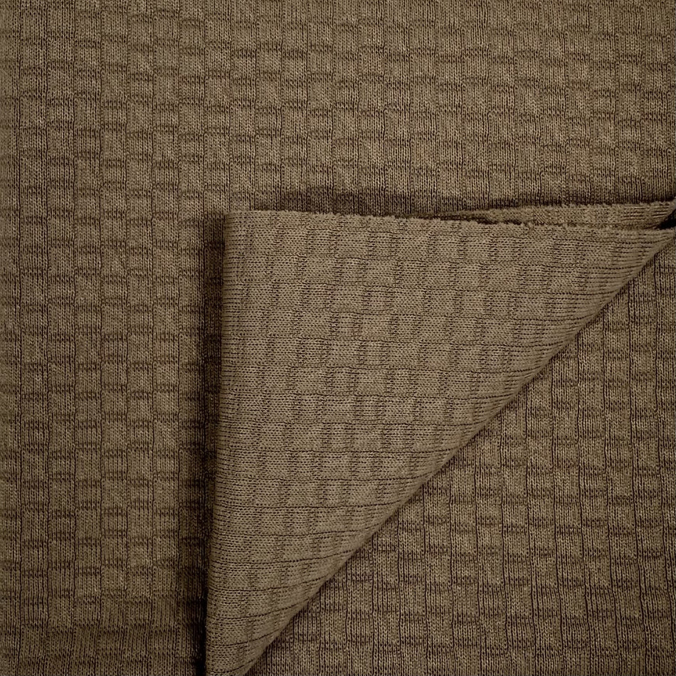 Brown textured fabric with a diagonal fold