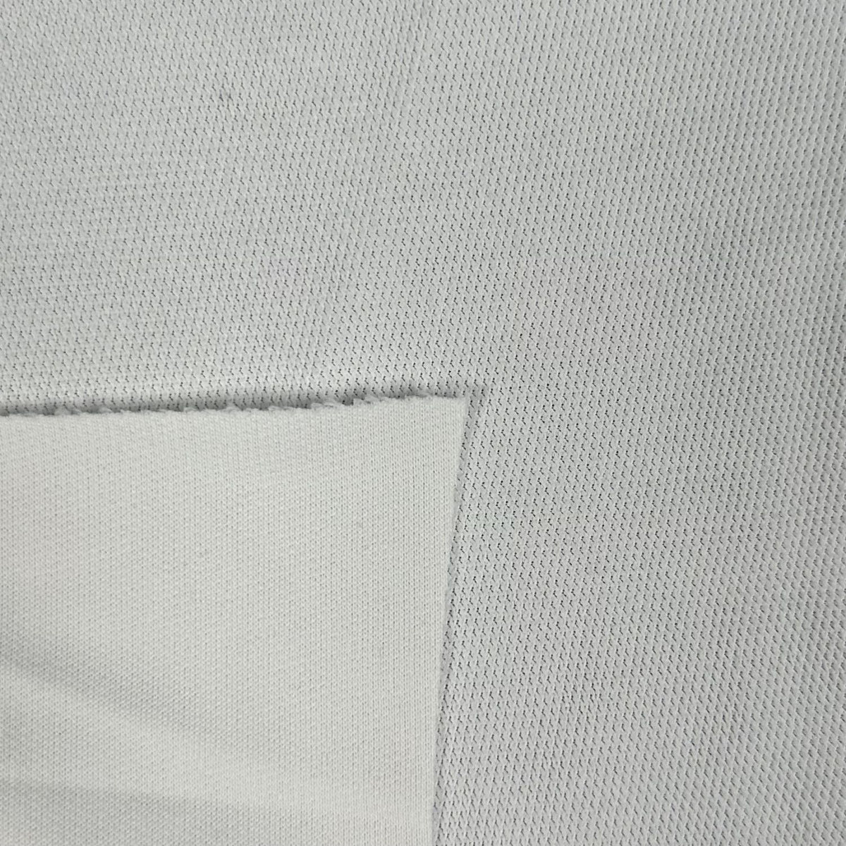 Close-up of a textured light gray fabric with a subtle pattern.