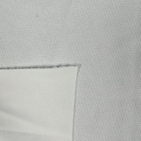 Close-up of a textured light gray fabric with a subtle pattern.