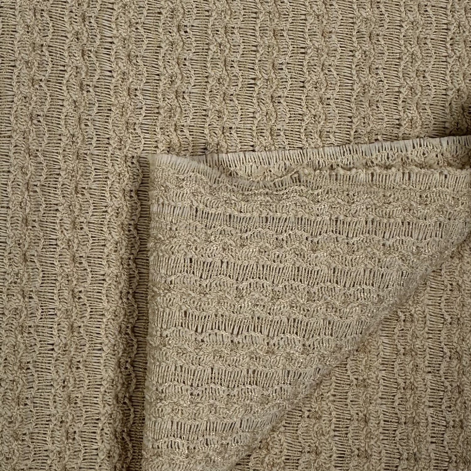 Close-up of beige textured fabric with a pocket detail