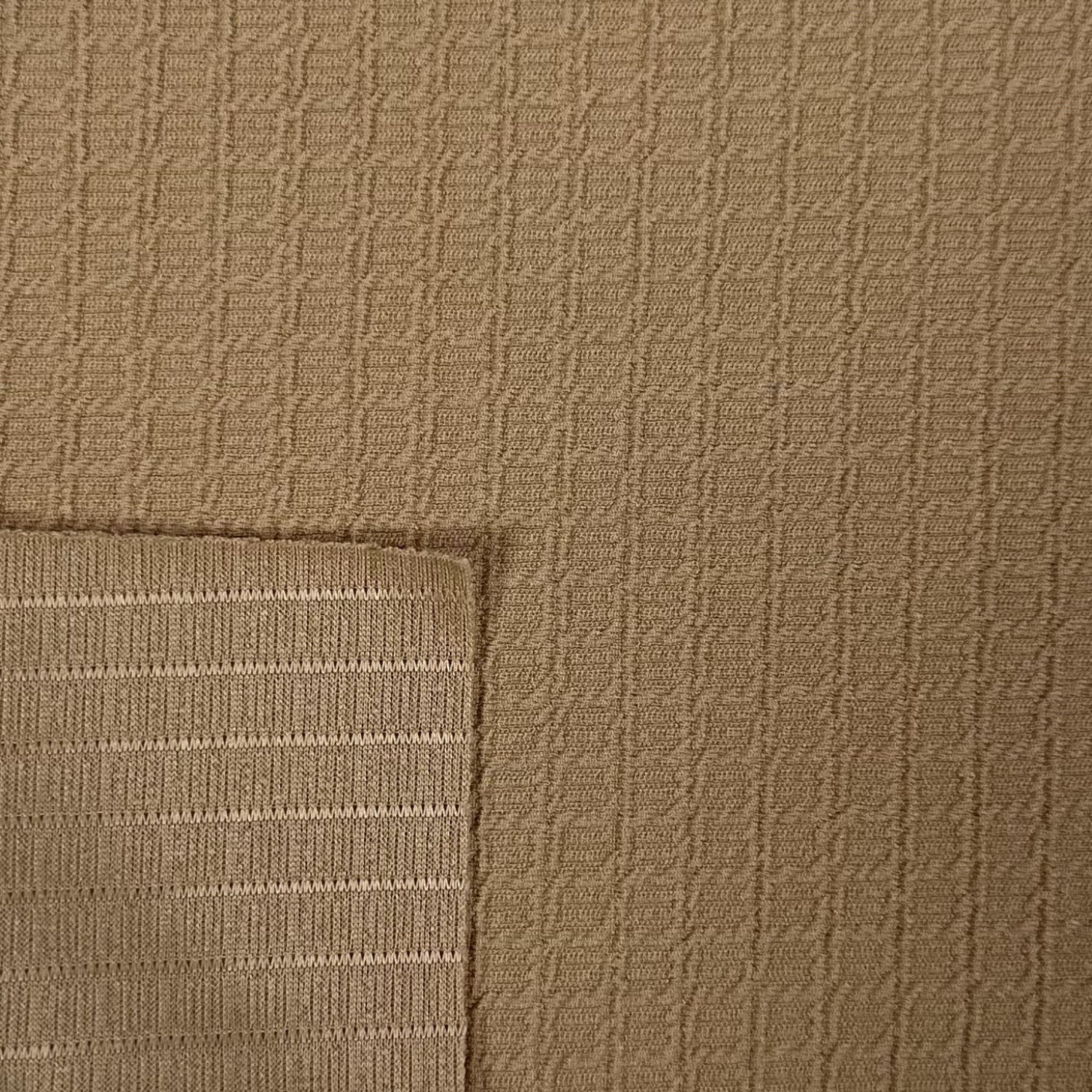 Close-up of brown textured fabric with a subtle pattern