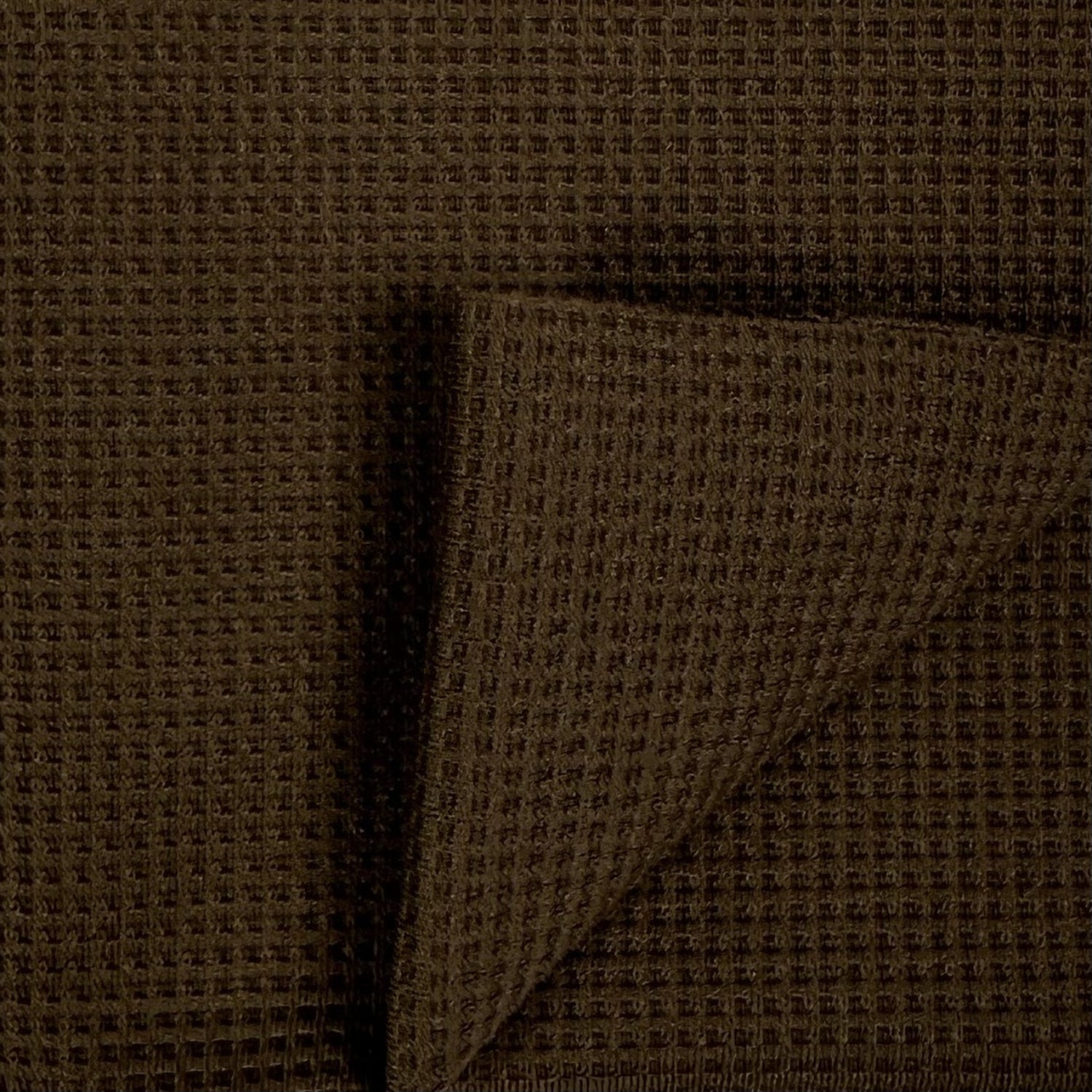 Close-up of brown fabric with a subtle pattern