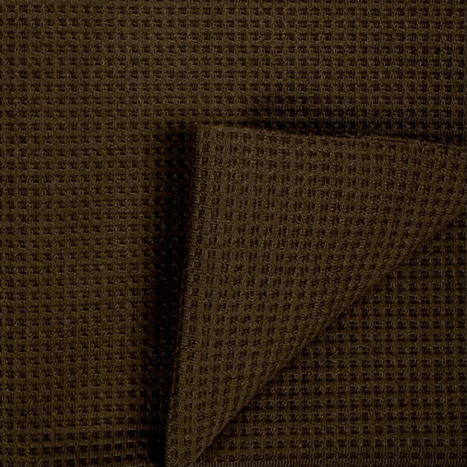 Close-up of brown fabric with a subtle pattern