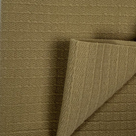 Close-up of brown textured fabric with a corner folded over