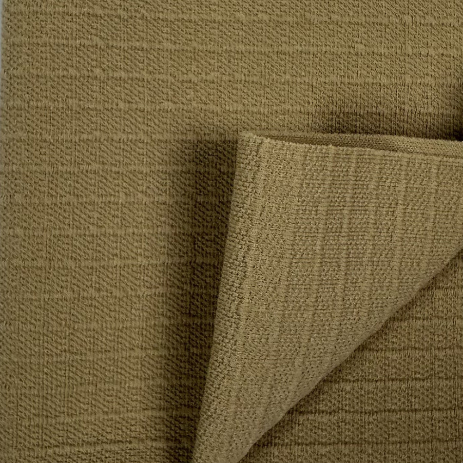 Close-up of brown textured fabric with a corner folded over