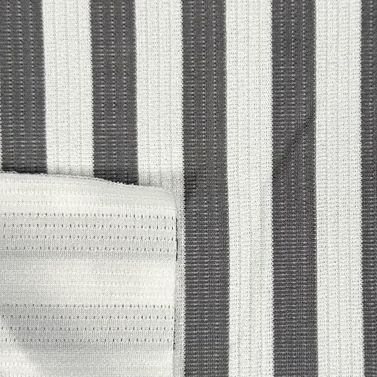 Close-up of a fabric with black and white vertical stripes.