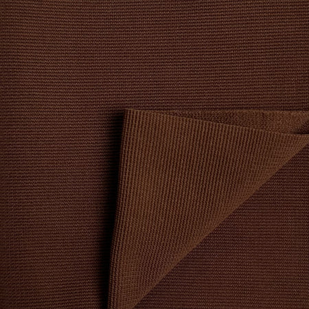 Close-up of brown textured fabric with a folded corner
