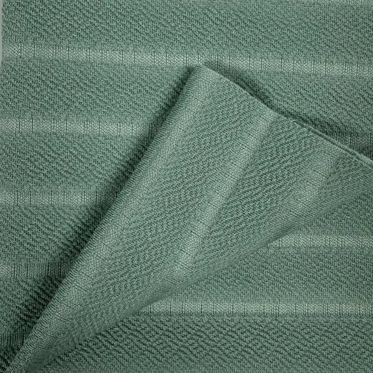 Close-up of green fabric with a textured pattern