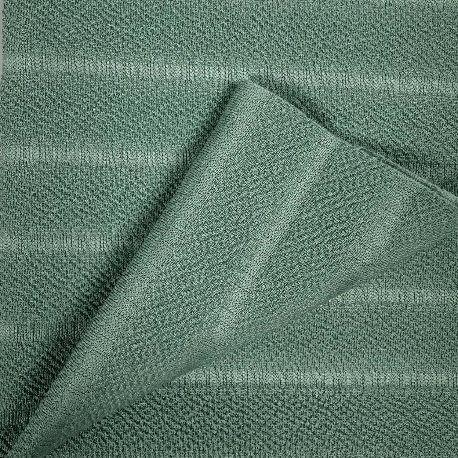 Close-up of green fabric with a textured pattern
