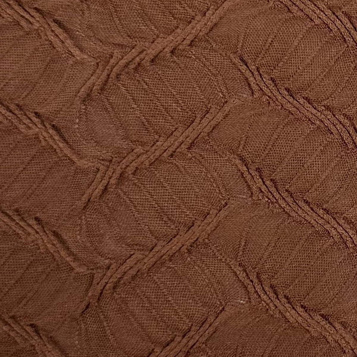 Close-up of brown textured fabric with a geometric pattern