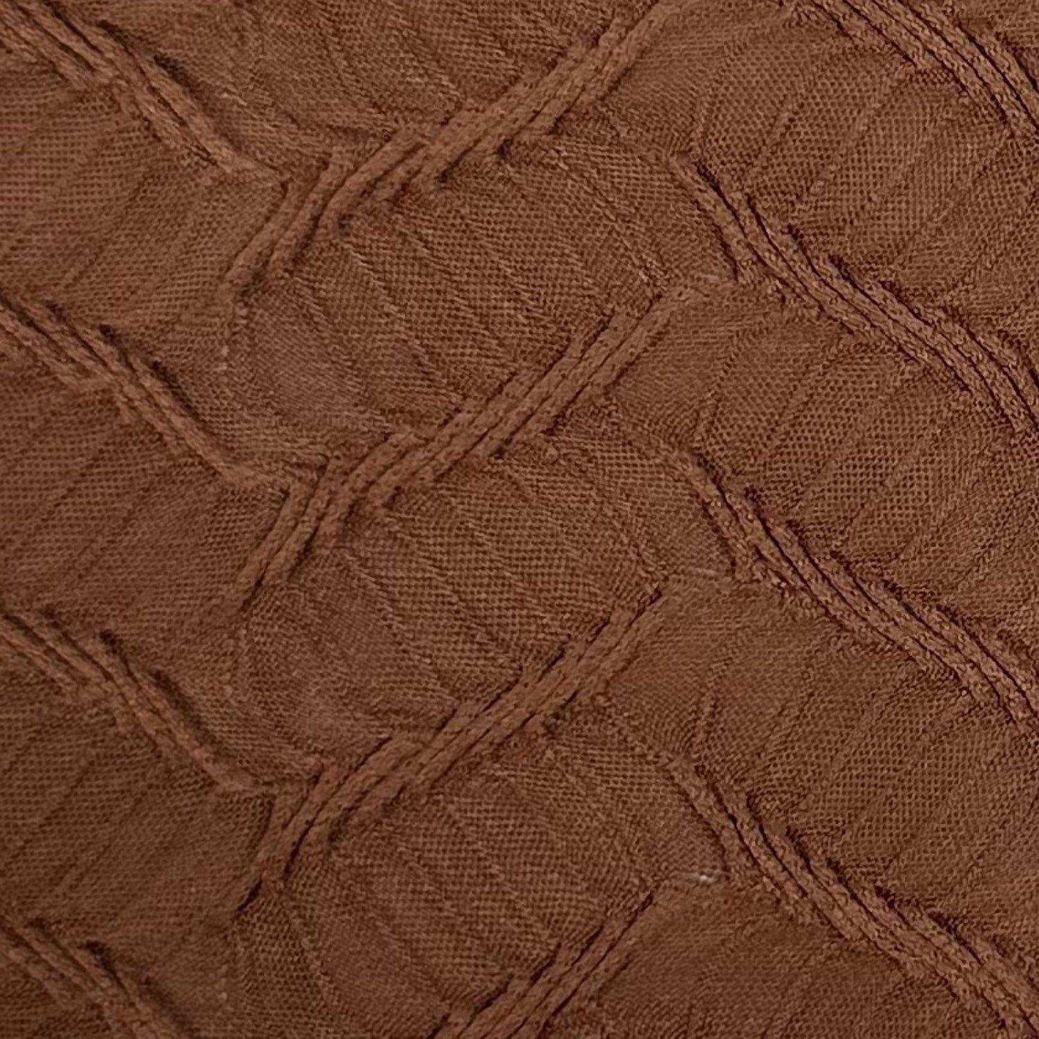 Close-up of brown textured fabric with a geometric pattern