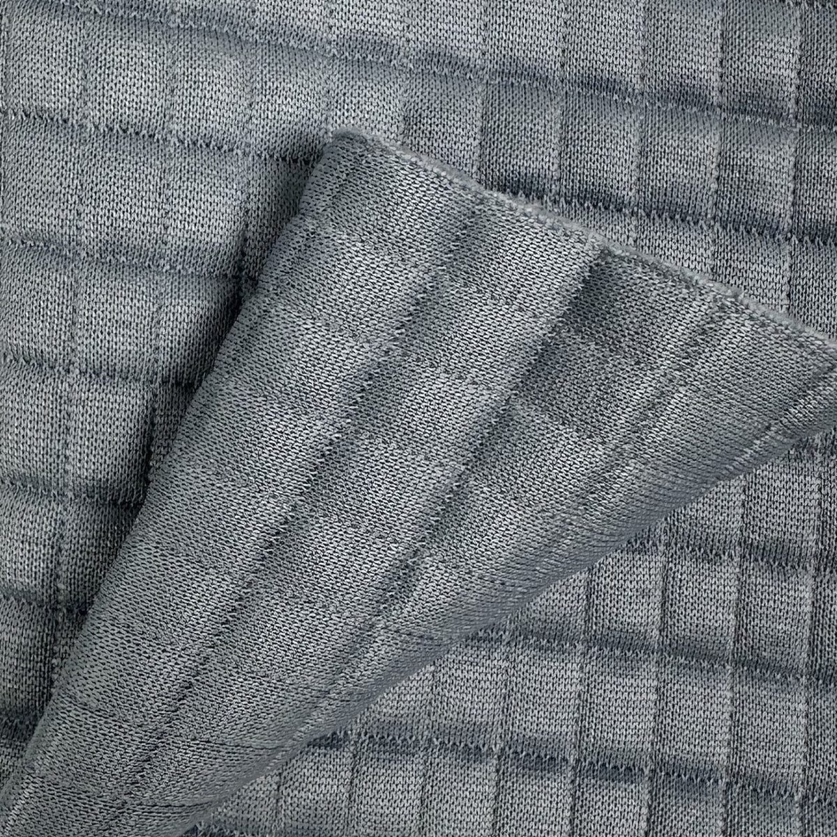 Close-up of textured gray fabric with a checkered pattern
