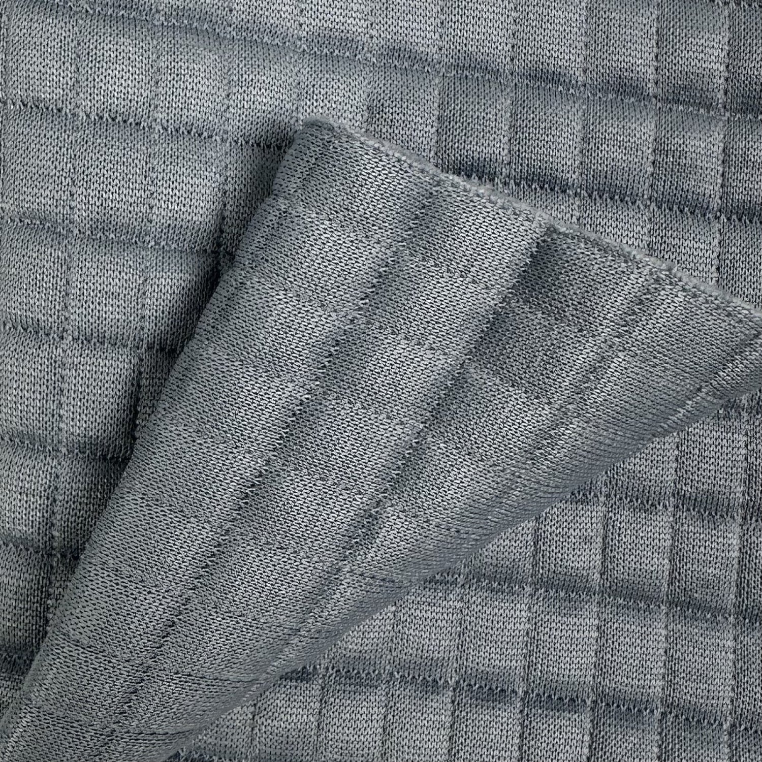 Close-up of textured gray fabric with a checkered pattern