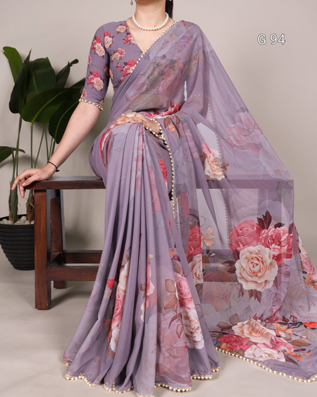 Woman wearing a floral saree with a gray background