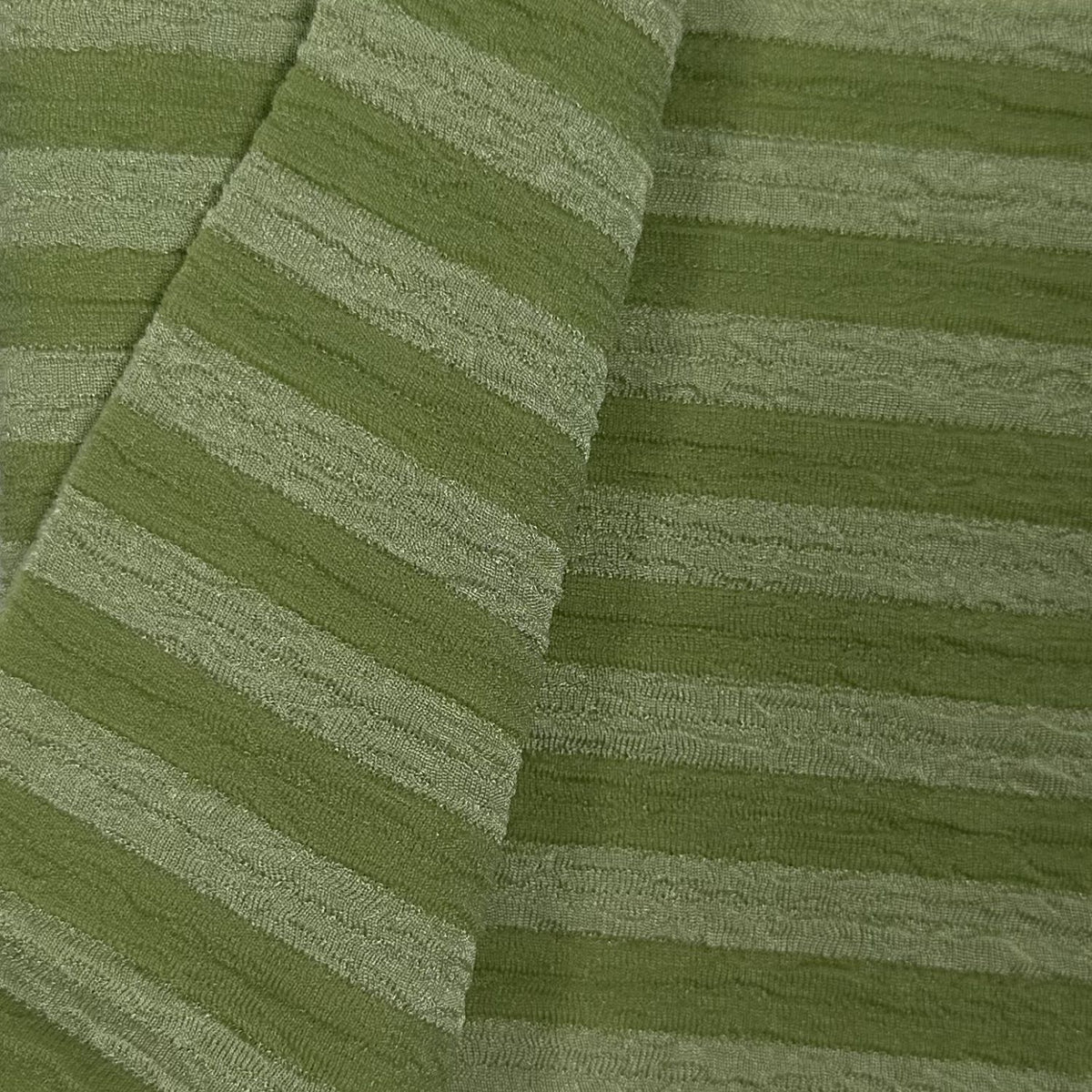 Close-up of green textured fabric with diagonal stripes
