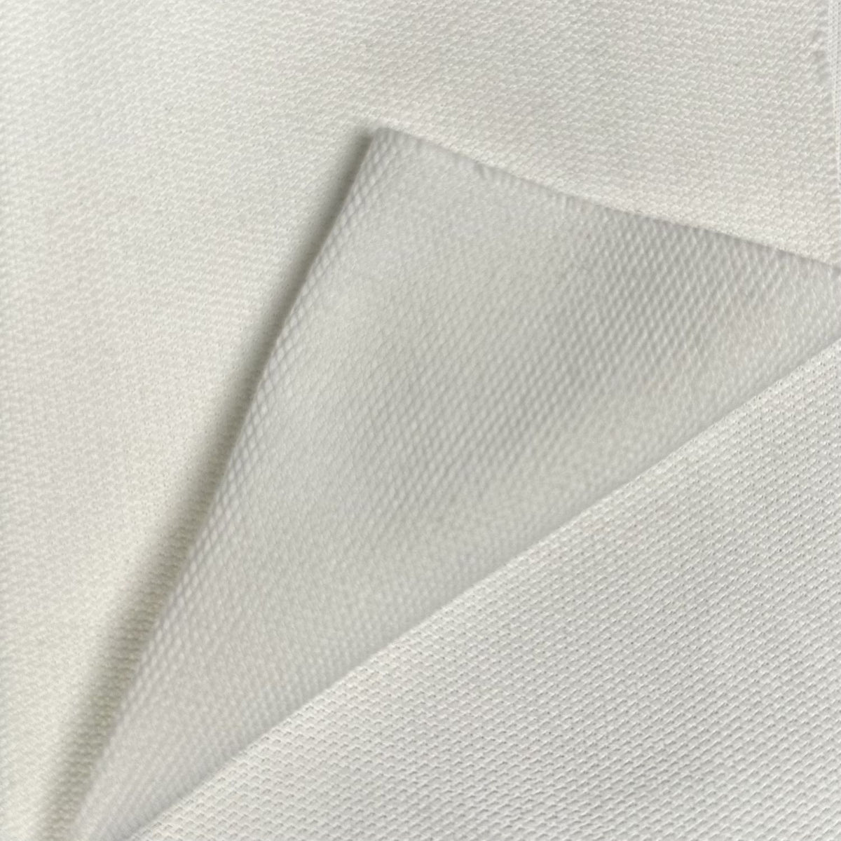 Close-up of textured white fabric with a subtle pattern