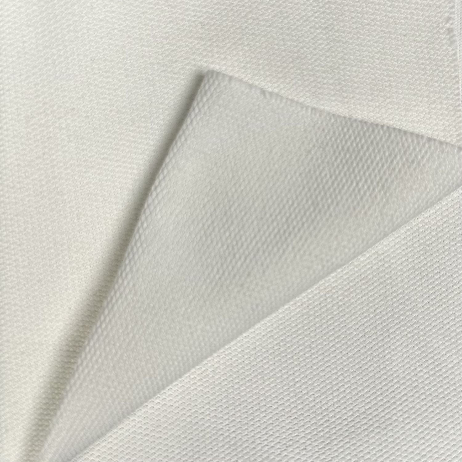 Close-up of textured white fabric with a subtle pattern