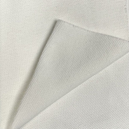 Close-up of textured white fabric with a subtle pattern