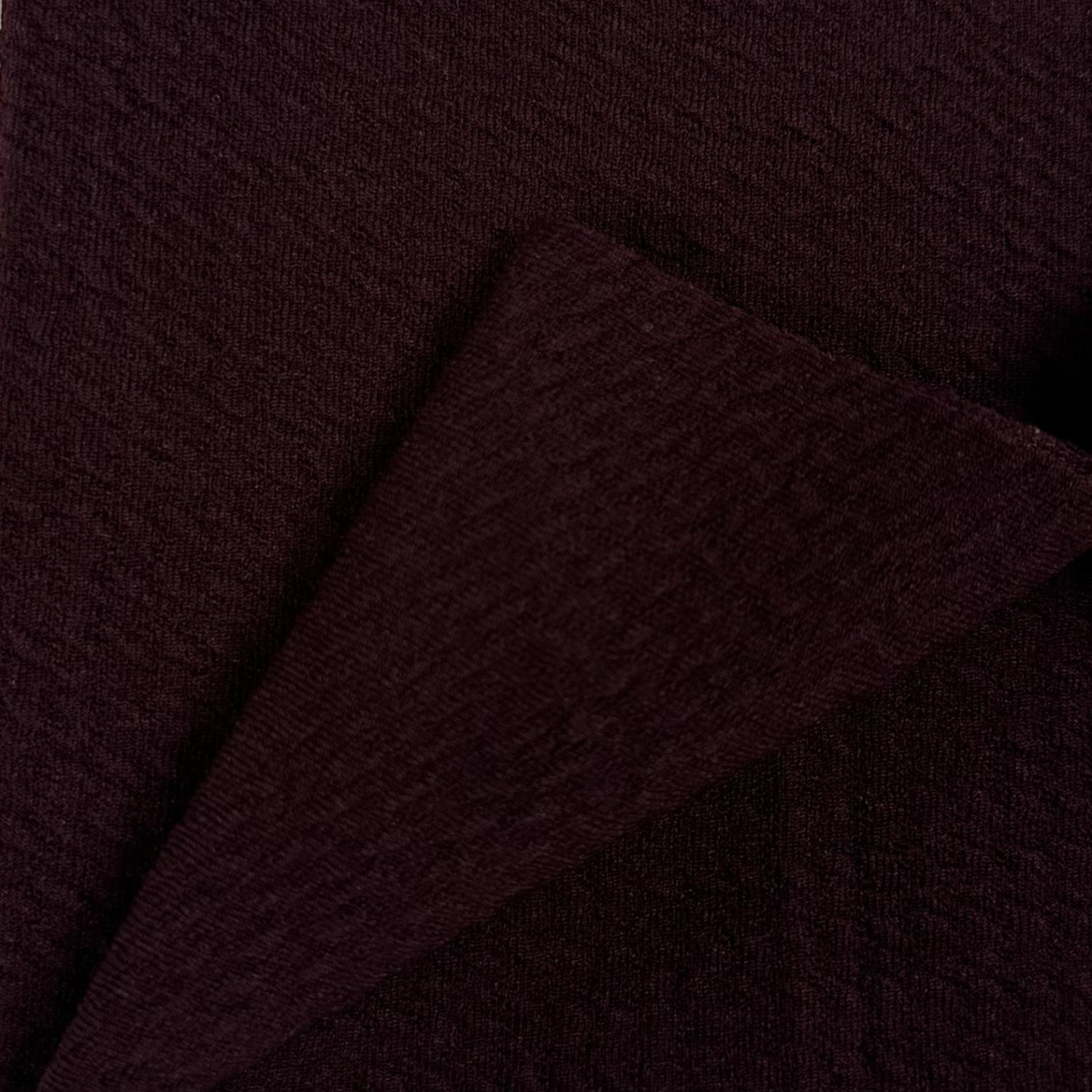 Close-up of dark brown fabric with a subtle texture