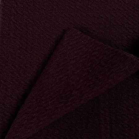 Close-up of dark brown fabric with a subtle texture