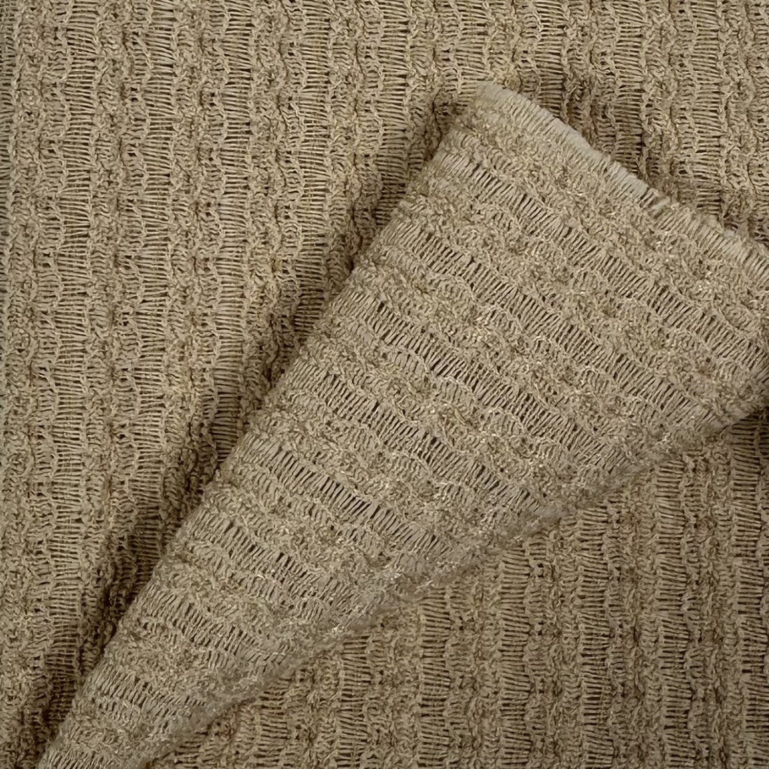 Close-up of textured beige fabric with a subtle pattern