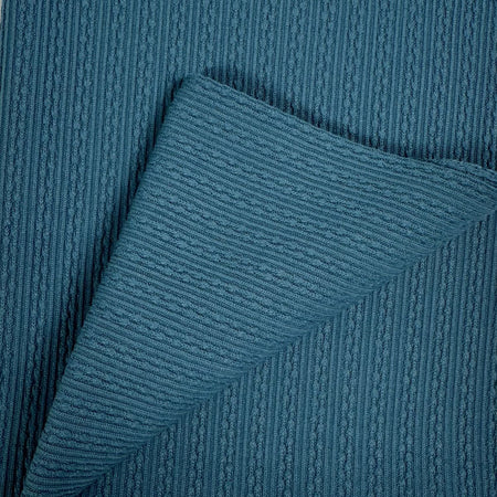 Close-up of a textured blue fabric with a subtle pattern