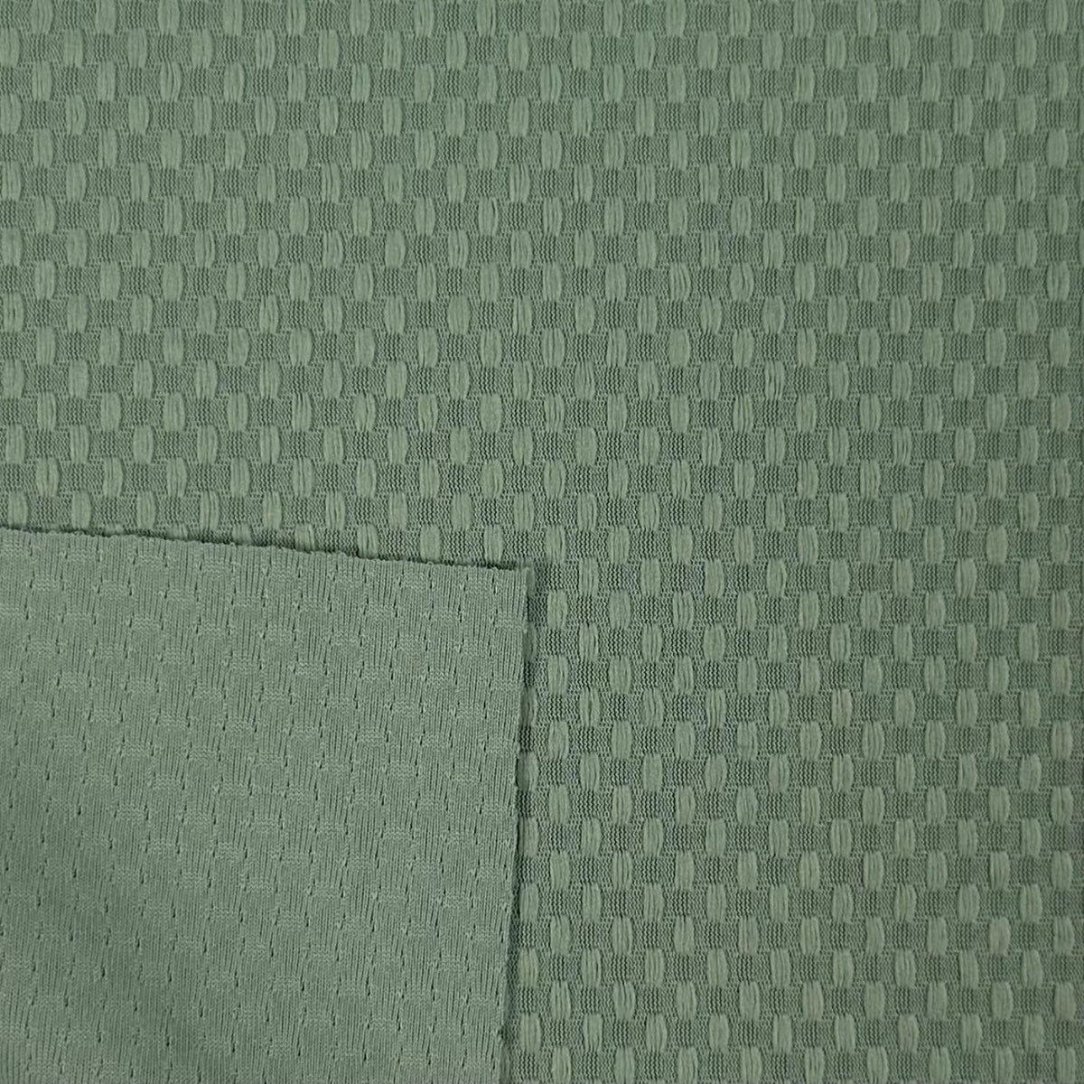 Close-up of green fabric with a subtle pattern