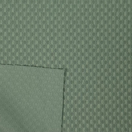 Close-up of green fabric with a subtle pattern