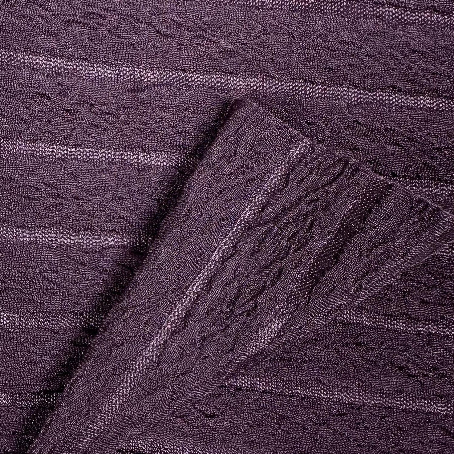 Close-up of purple textured fabric with a cable knit pattern