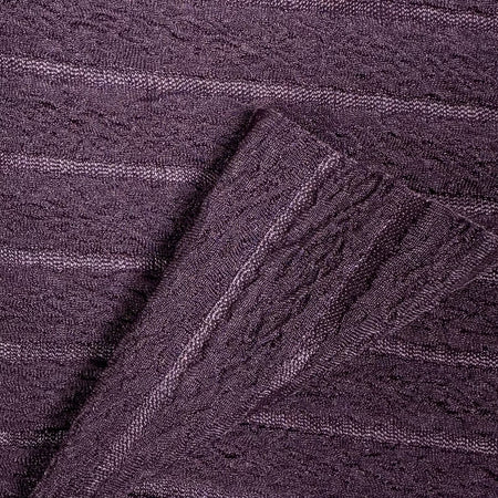 Close-up of purple textured fabric with a cable knit pattern
