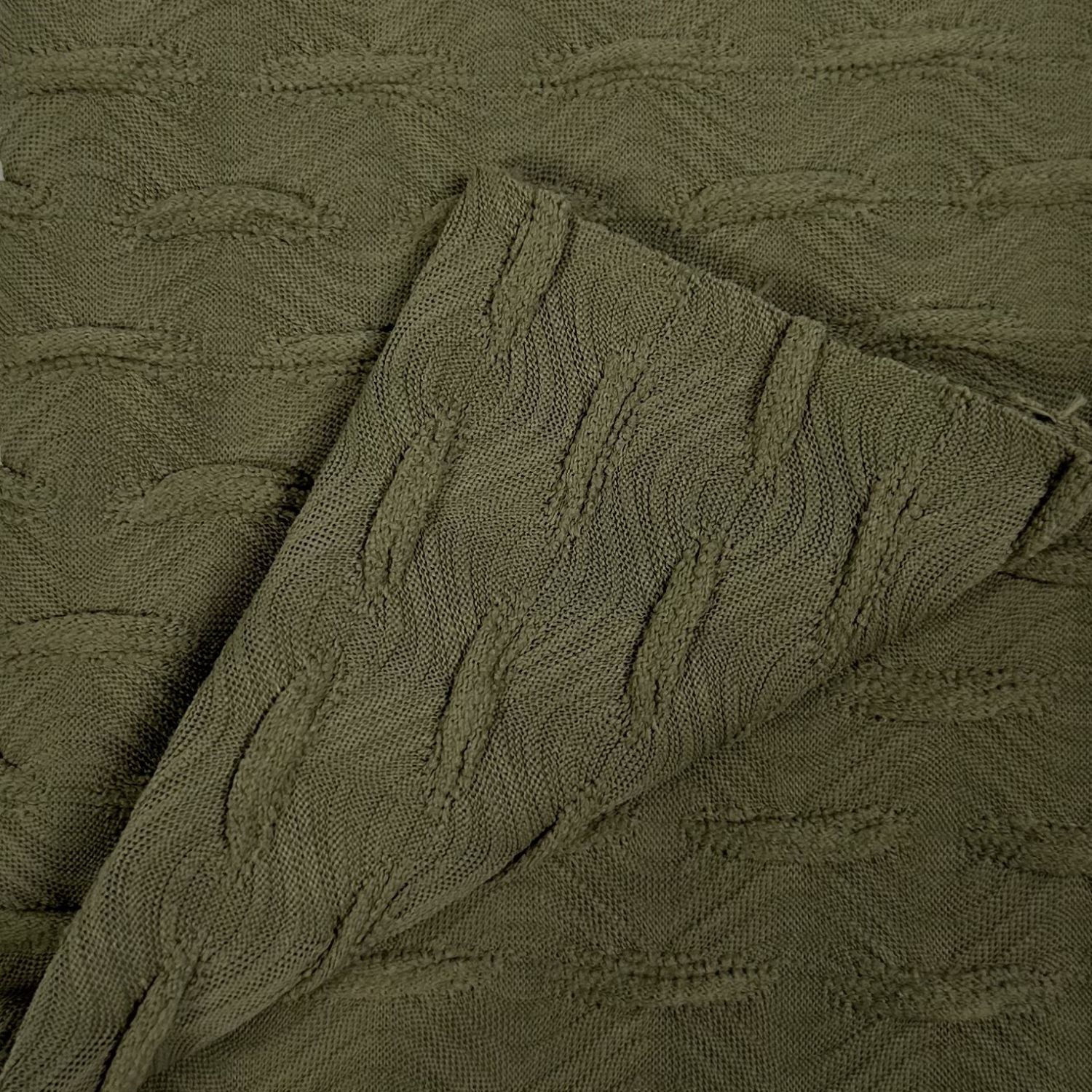 Close-up of textured olive green fabric with a subtle pattern